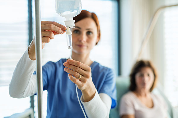 Saline back dripping while nurse holds it